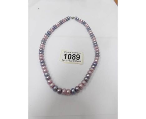 An Honora pearl necklace in lilac/blue colours.