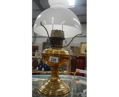 A brass oil lamp with shade.