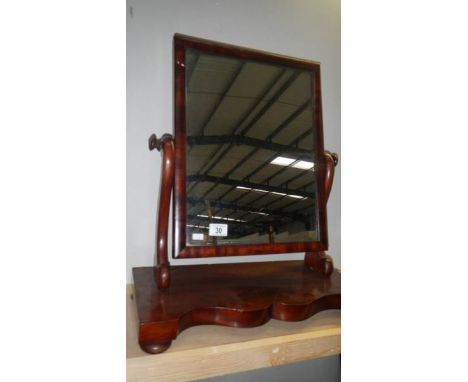 A mahogany toilet mirror.