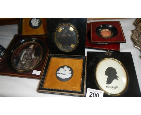A silhouette, an oval portrait, 3 framed Wedgwood plaques etc.,