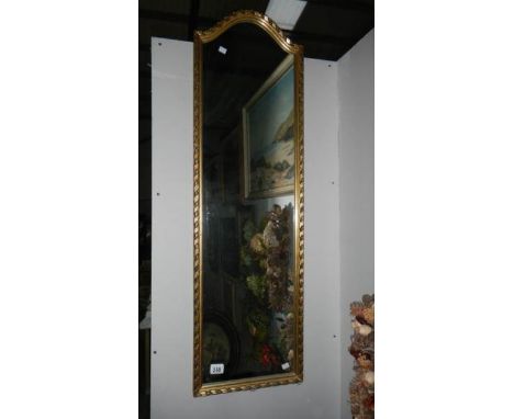 A gilt framed mirror.