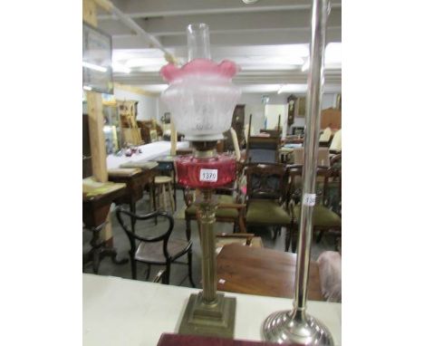 A brass Corinthian column oil lamp with shade and chimney.
