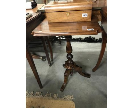 A mahogany tripod table.