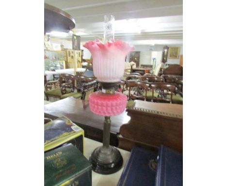 A Victorian oil lamp with glass font, complete with shade and chimney.