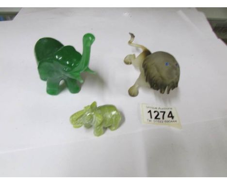 A jade elephant, another elephant and a lion,.