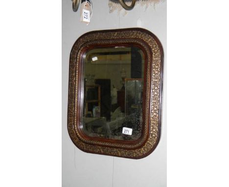 An antique framed bevel edged mirror.