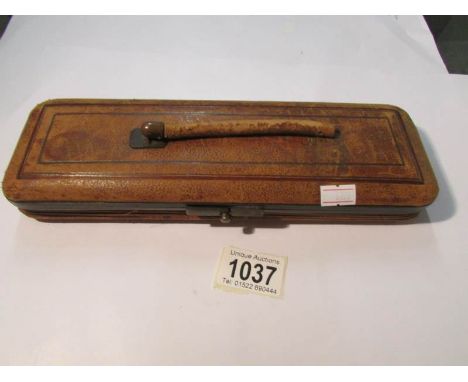 A 19th century glove case (handle a/f) containing a pair of 19th century ivory glove stretches.