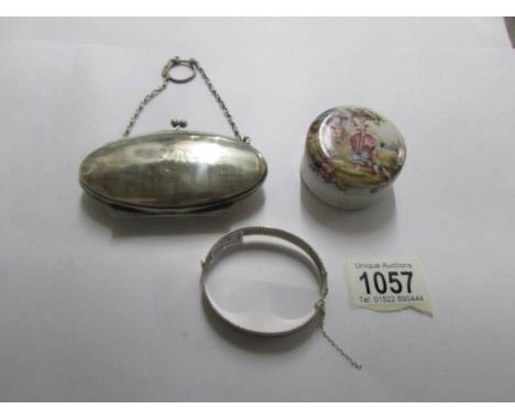 An engraved silver bangle, a silver purse and a ceramic trinket box.