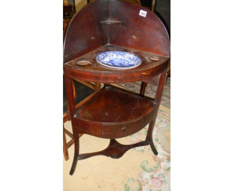 A mahogany corner washstand with blue and white basin.