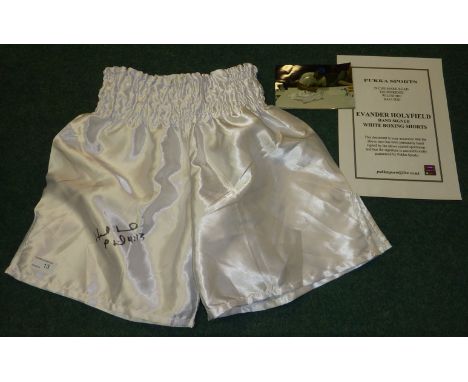 Pair of signed Evander Holyfield white boxing shorts with certificate and photograph 