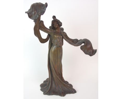 A FRENCH ART NOUVEAU PATINATED SPELTER LADY LAMP  modelled standing with arms outstretched holding the light fitments, with F