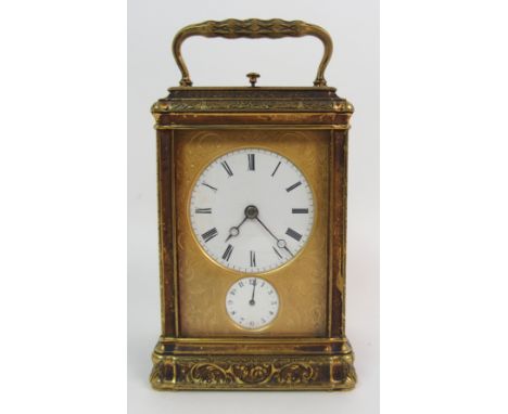 A BRASS CASED REPEATER ALARM CARRIAGE CLOCK  the enamelled dial with Roman numerals and with a secondary alarm dial with Arab