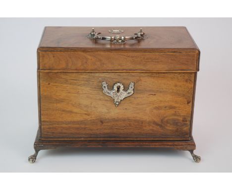 A REGENCY WALNUT TEA CADDY with hinged lid, with white-metal mounted decoration and similar swing handle, on white-metal claw