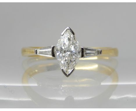 AN 18CT GOLD MARQUIS DIAMOND RING  of estimated approx 0.57cts, with tapered baguette diamond shoulders taking the estimated 