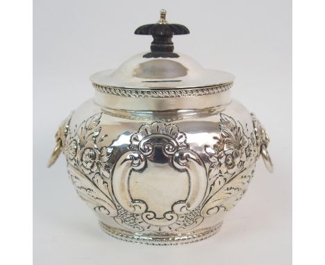 AN EDWARDIAN SILVER TEA CADDY unclear maker's marks, Birmingham 1902, the bulbous body with foliate embossed decoration, blan