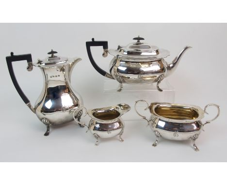 A FOUR-PIECE SILVER TEA SERVICE by William Hutton & Sons, Sheffield 1925, of baluster shape with scalloped borders on four ou