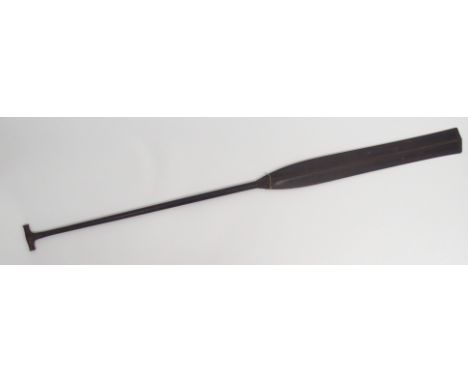 A FINELY CARVED BORNEO CEREMONIAL PADDLE the bifurcated blade with Gordian knot band below five carved bands with T-bar shape
