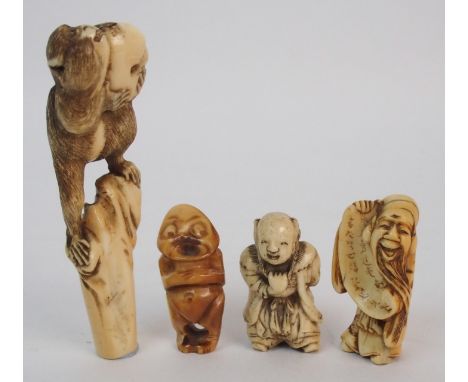 A JAPANESE IVORY PARASOL HANDLEcarved with a monkey holding a nut, 9.5cm high, netsuke of a scholar holding a scroll, 4.5cm h