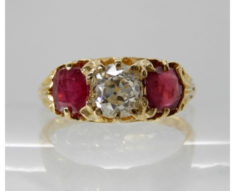 AN 18CT GOLD RUBY AND DIAMOND RING  the central old cushion cut diamond is estimated approx 0.80cts and flanked by two cushio