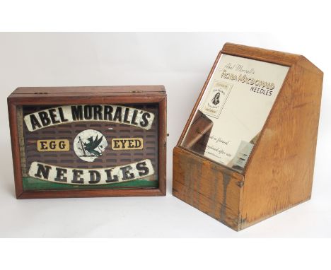 AN OAK CASED FIVE DRAWER NEEDLE CASE WITH MIRROR ADVERTISING PLATE, ABEL MORRALL'S FLORA MACDONALD NEEDLES 32 x 23cm and an A