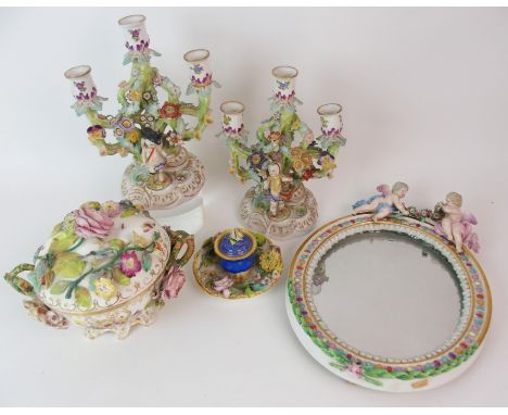 A MEISSEN WALL MIRROR the oval plate in a frame with moulded leaves and jewelled decoration, surmounted by a pair of cherubs 