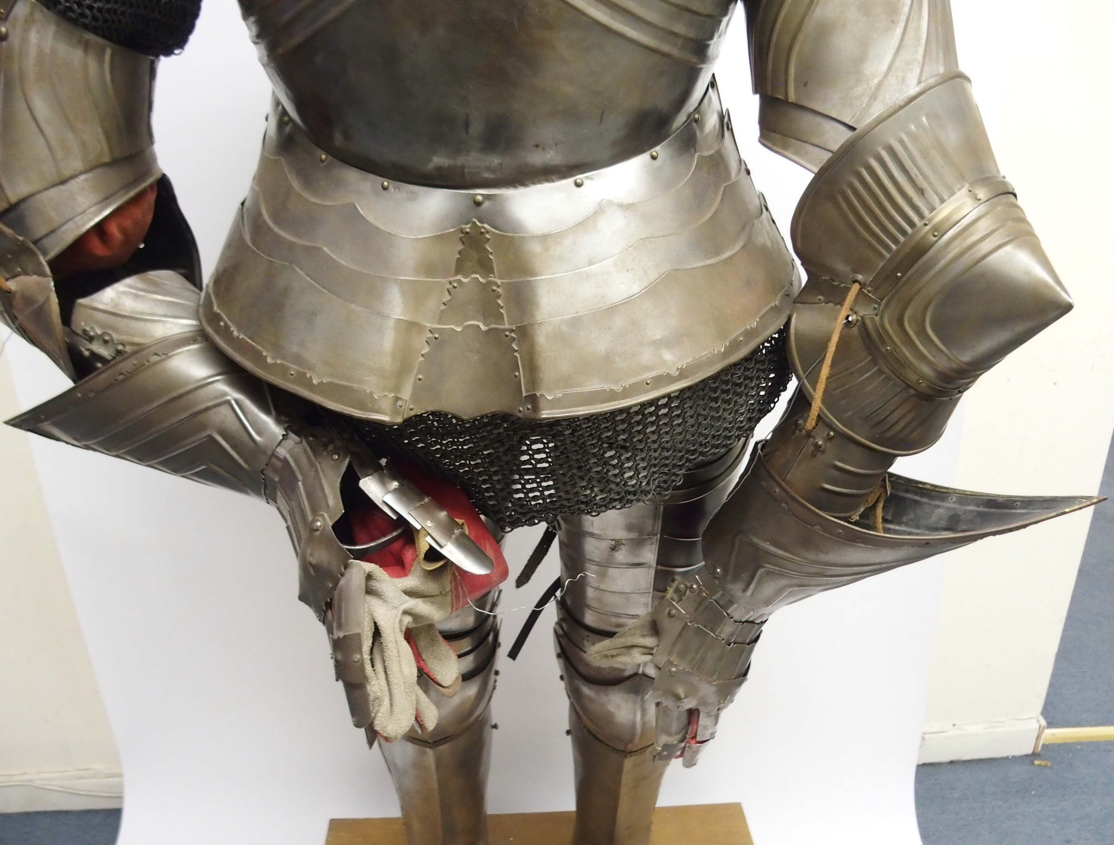 A STEEL SUIT OF ARMOUR of articulated construction, standing with ...