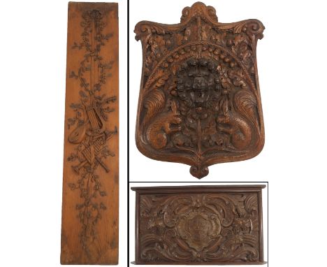 AN OAK ARMORIAL PANEL carved with a coat-of -arms within a scrolling cartouche with grapes and corn, 63cm high x 103cm wide a