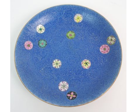 A CHINESE PORCELAIN DISH  with incised scrolling and enamel foliage on a blue ground, blue seal mark, 25.5cm diameter   Condi