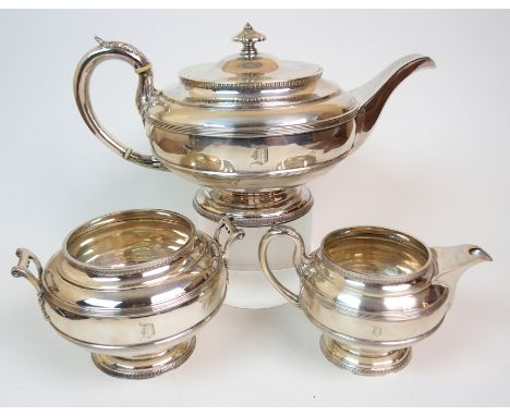 AN EDWARDIAN THREE-PIECE SILVER TEA SERVICE by Lawson & Co., Glasgow 1908, of spherical form, the body with two ribbed bands,