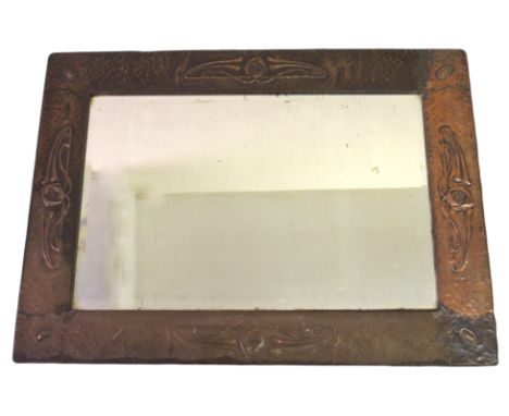 A GLASGOW SCHOOL ARTS AND CRAFTS COPPER FRAMED MIRROR  of rectangular form, the hammered ground with Glasgow Rose style decor