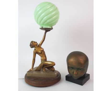 AN ART DECO LADY LAMP modelled semi-clad holding aloft a green glass globe, upon onyx base and wooden plinth, 44cm high, toge