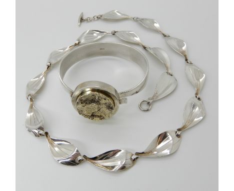 A RETRO BANGLE AND NECKLACE BY DANISH DESIGNER HERMAN SIERSBOL  both hallmarked 925S. Bangle set with a gold plated rough cas