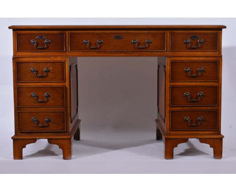 Reproduction yew wood twin pedestal desk, tooled leather inset fitted with three frieze drawers, and three drawers to each pe