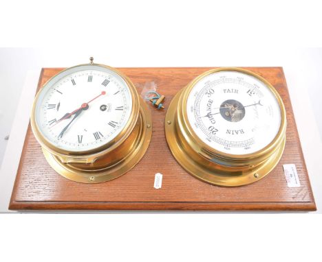 Brass case ships clock, enamel dial signed Mercer, St Albans, diameter 19cm, mounted on an oak board with barometer, signed F