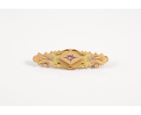 Victorian 9ct gold brooch, set with a ruby and a 9ct brooch set with an amethyst, (2).