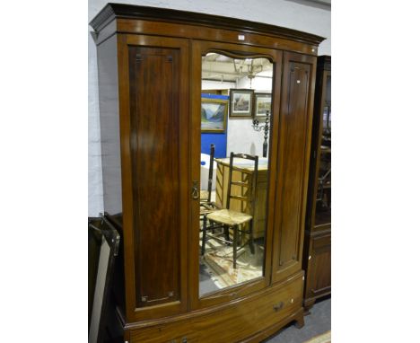 Edwardian mahogany bowfront wardrobe, centre mirrored panel door, single drawer under, splayed bracket feet, width 140cm.