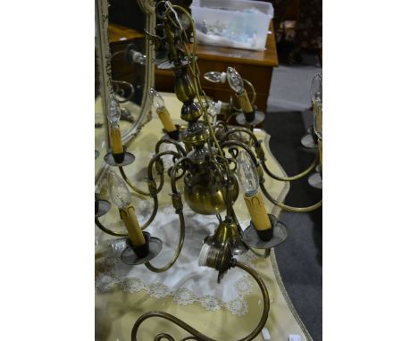 Dutch style lacquered brass eight light chandelier, scrolled branches, 53cm drop and a pair of similar two branch wall lights