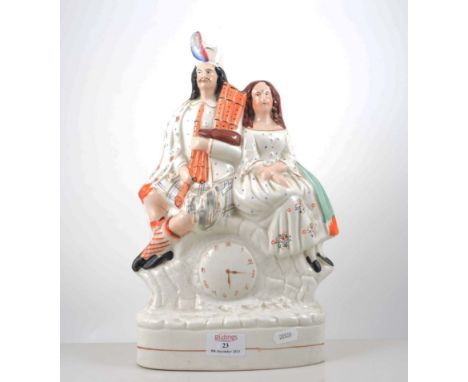 Staffordshire flat back clock group, modelled with a Scottish couple, 26cm, another Staffordshire figure of a Scotsman, three
