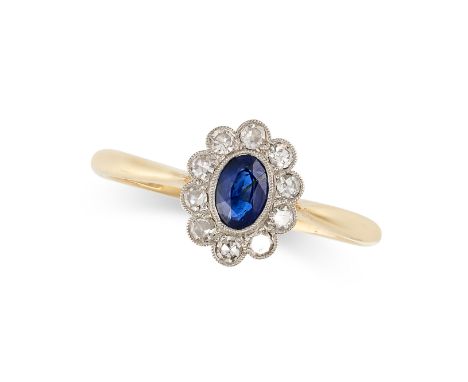 NO RESERVE -&nbsp;A SAPPHIRE AND DIAMOND CLUSTER RING in 18ct yellow gold and platinum, set with an oval cut blue sapphire wi