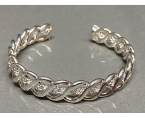 A silver torc style bangle 18.2g