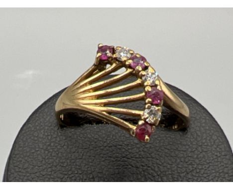 Ladies 9ct gold ruby and diamond ornate ring. Featuring 3 diamonds and 4 rubies. 1.8g size P