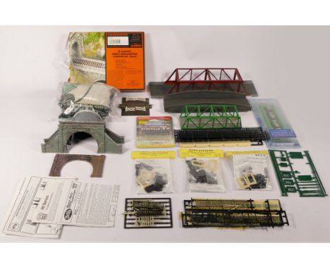 A box of 'N' gauge model railway equipment to include, engine spates, track, underlay and ballast, controller, switches and a