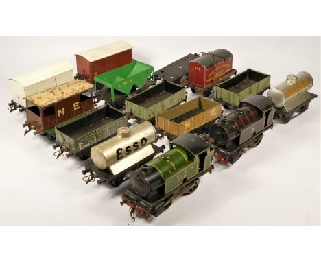 Two suitcases of 'O' gauge clockwork model railway items, to include track, engines, wagons, coaches and station accessories,