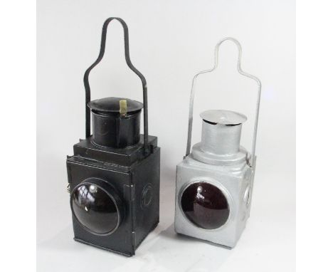 A black unmarked tail lamp, with burner and a silver painted unmarked tail lamp 