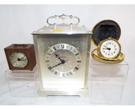 A Stiger mantle clock, a Europa two jewel wind-up travel clock and one other wind-up travel clock (3)