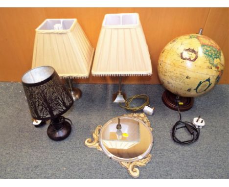 Three table lamps, a round bevel edged wall mirror and a novelty lamp in the form of a globe (qty)