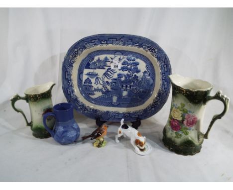 A good mixed lot to include a blue and white Staffordshire meat plate, a Beswick bird, impressed marks to the base 991, a Roy