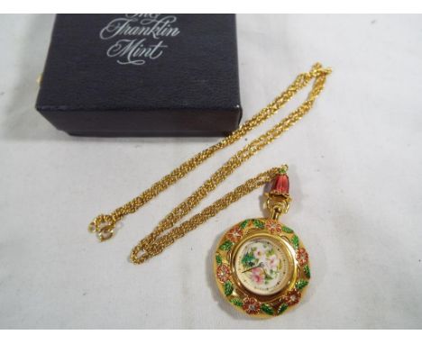 Franklin Mint - a lady's good quality Franklin Mint pocket watch and chain with a relief floral decoration, boxed