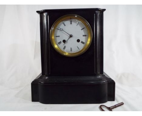 A slate mantel clock, Roman numerals on a white dial marked Payne & Co, Paris striking the hour and half hour on a gong with 
