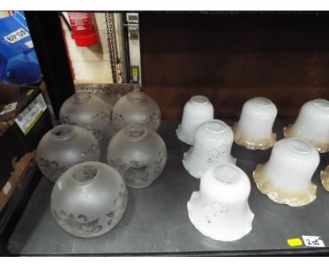 A collection of approximately sixteen glass light shades, various designs and matching sets